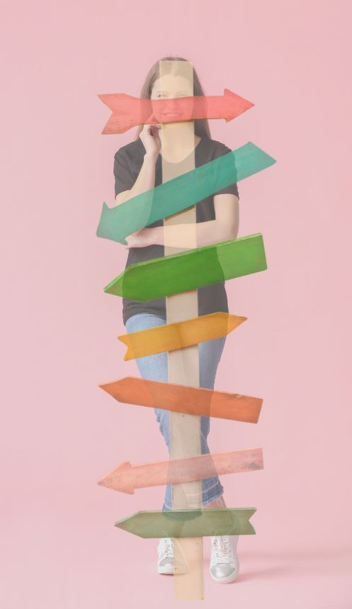 Multicoloured directional signs superimposed over young woman